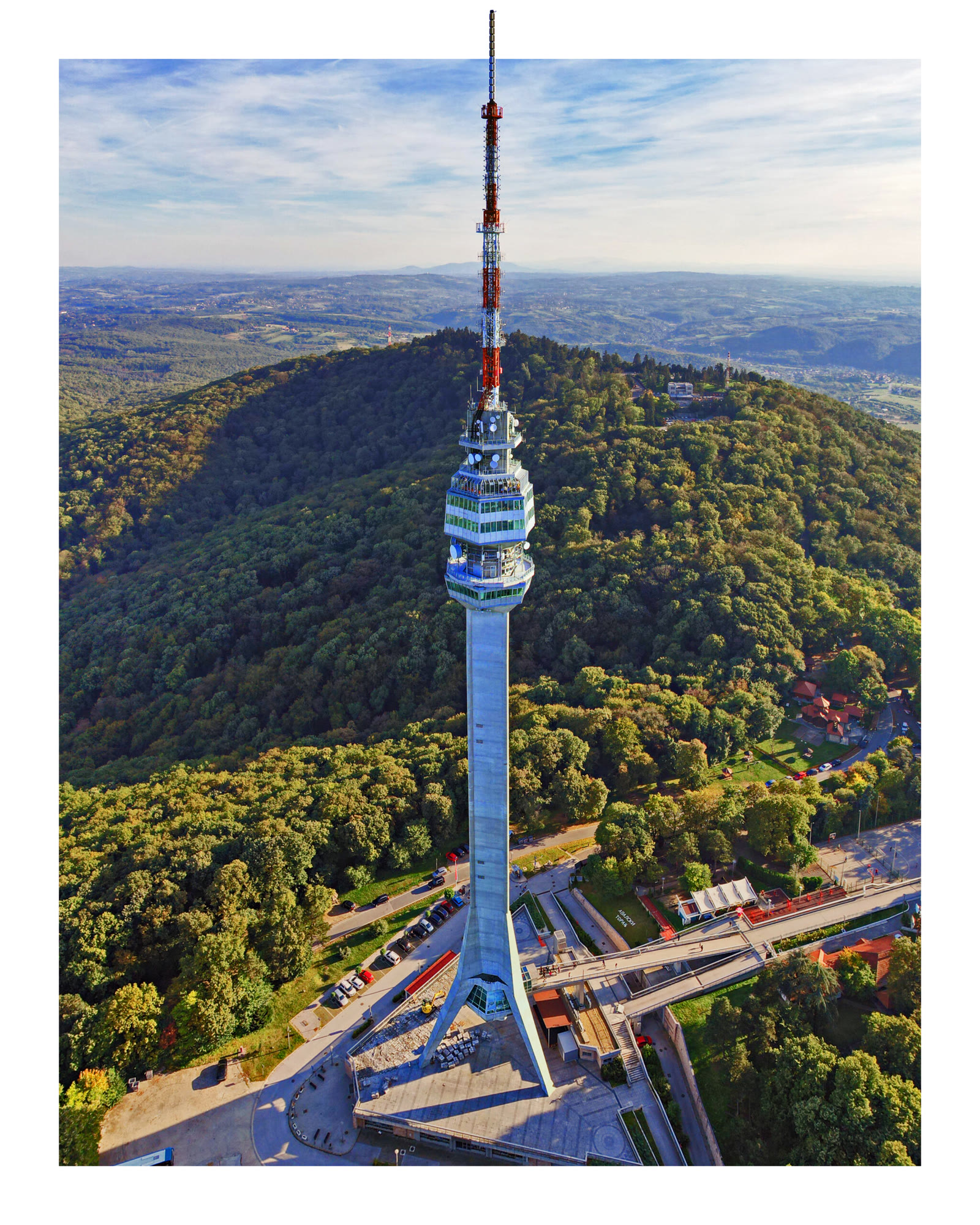 Aerial view of Avala Tower extending beyond a white photographic frame