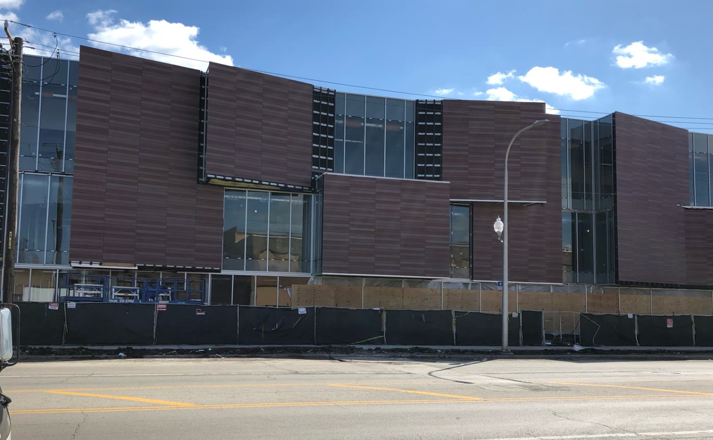 Building clad with warm wood-tone EKS panels